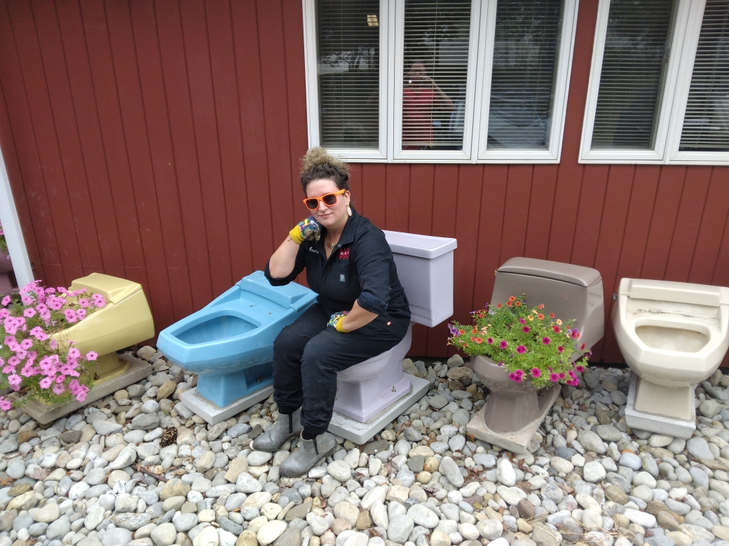 Audra sitting on misty lilac toilet